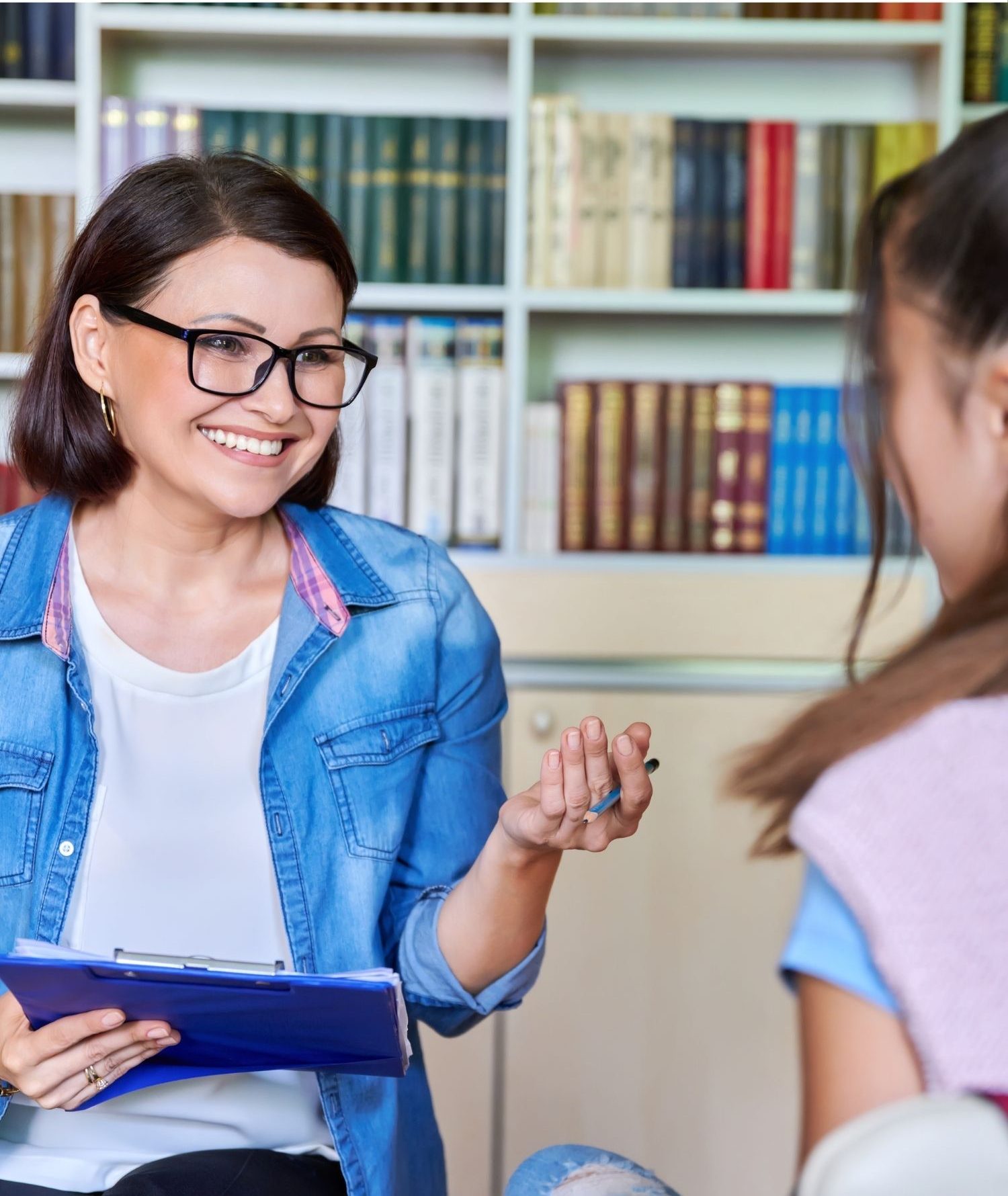 A female social worker speaking with a child.