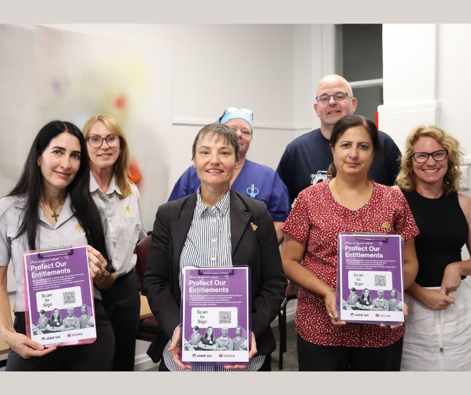 HSUWA Members stand together holding the petition to the State Government.