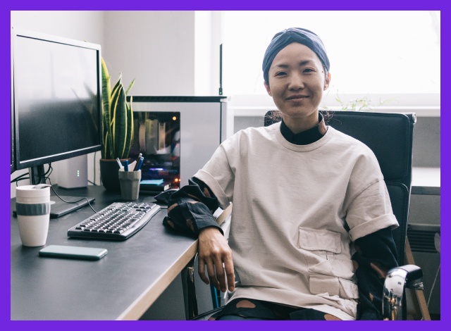 A health worker sits at a desk with a computer. Image supplied by HESTA.