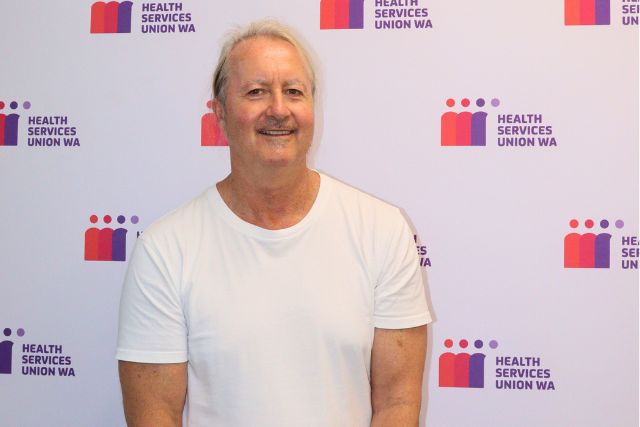 HSUWA President Craig Russell smiling in front of a HSUWA background.