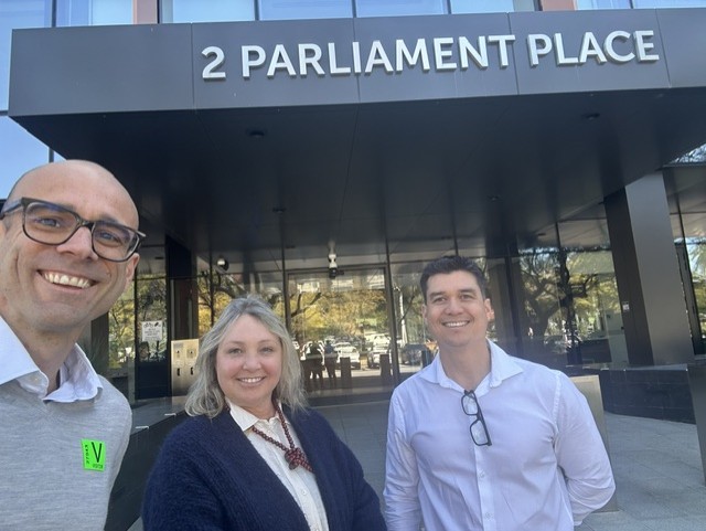 Julien Graciet, HSUWA Secretary Naomi McCrae, and HSUWA Vice President Jonothan Nugent stand at the front of Dumas House.
